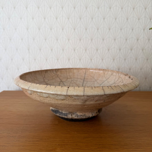 Antique French crackle pottery bowl with footed pedestal base, side view showing pale cream glaze and brown crackle pattern