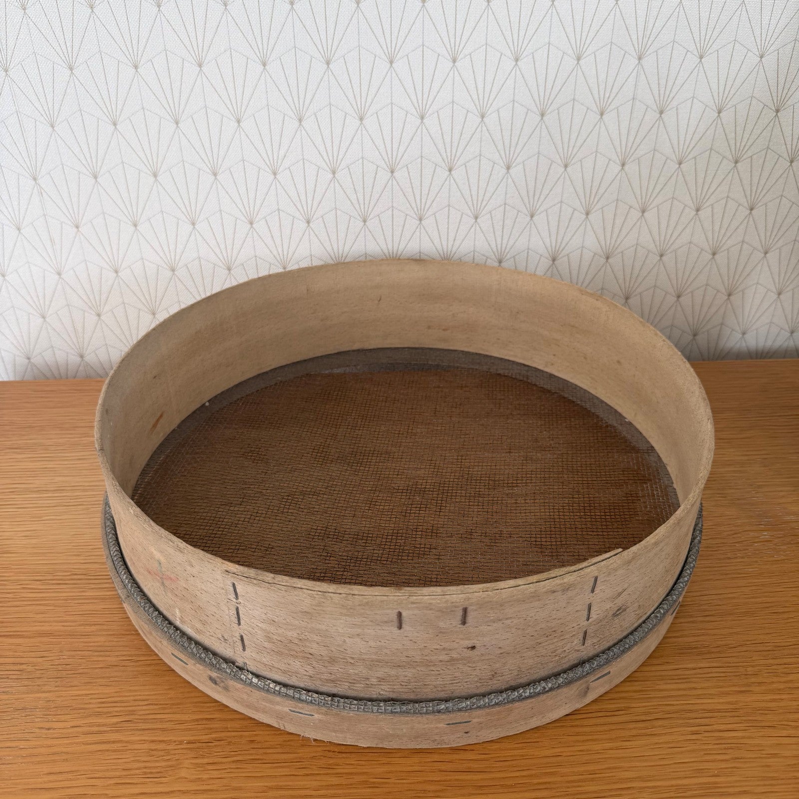Top view of antique French flour sieve displaying woven mesh base interior