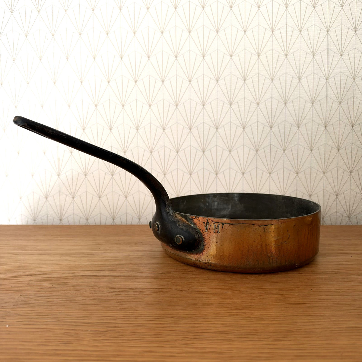 Antique French copper saute pan with curved black iron handle and E. Dehillerin stamp