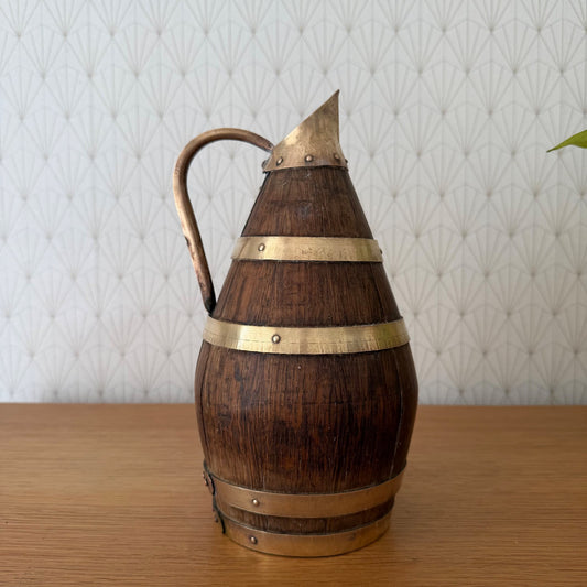 Antique French wooden wine pitcher with brass bands and pointed spout, front view