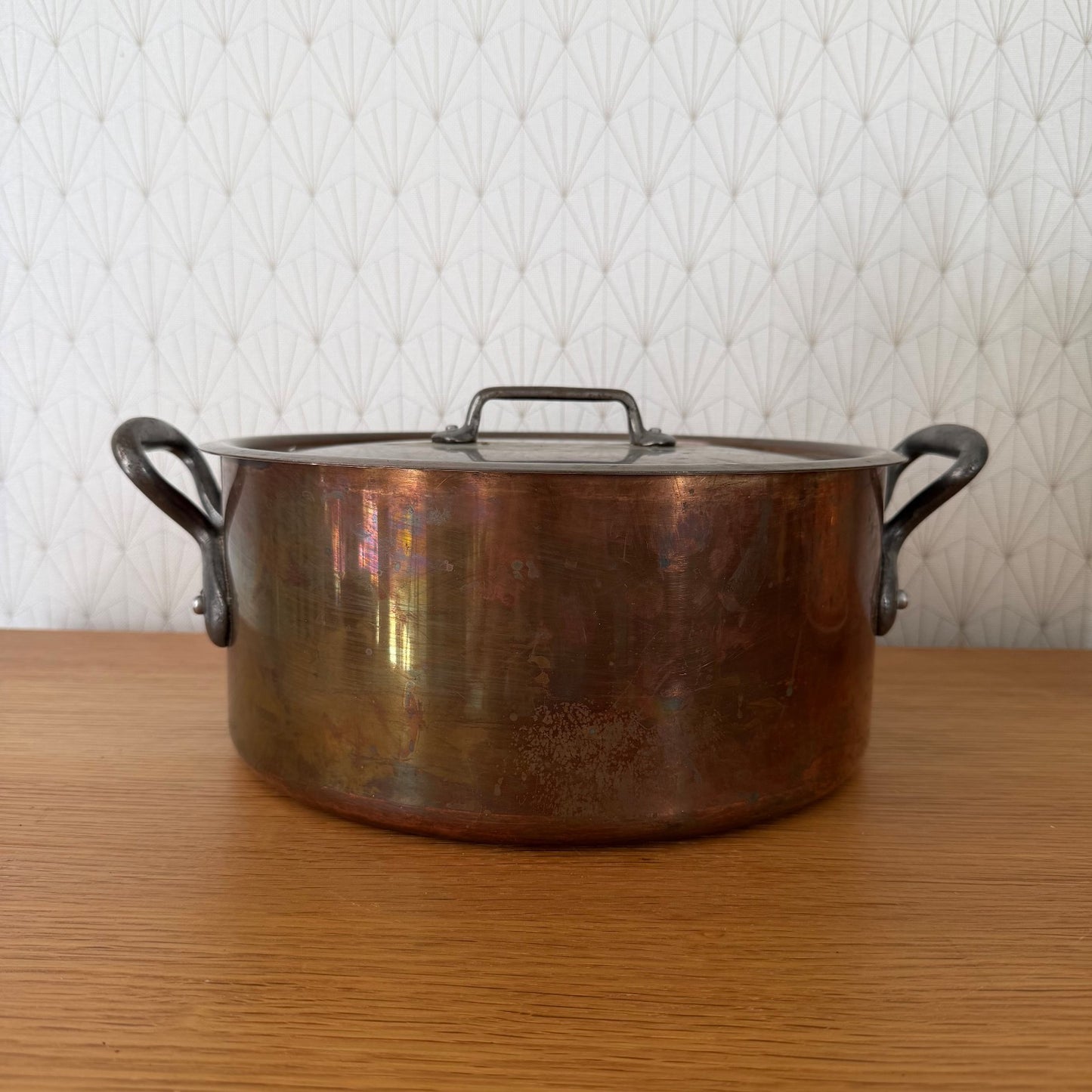French copper cocotte with dual cast iron handles and matching lid