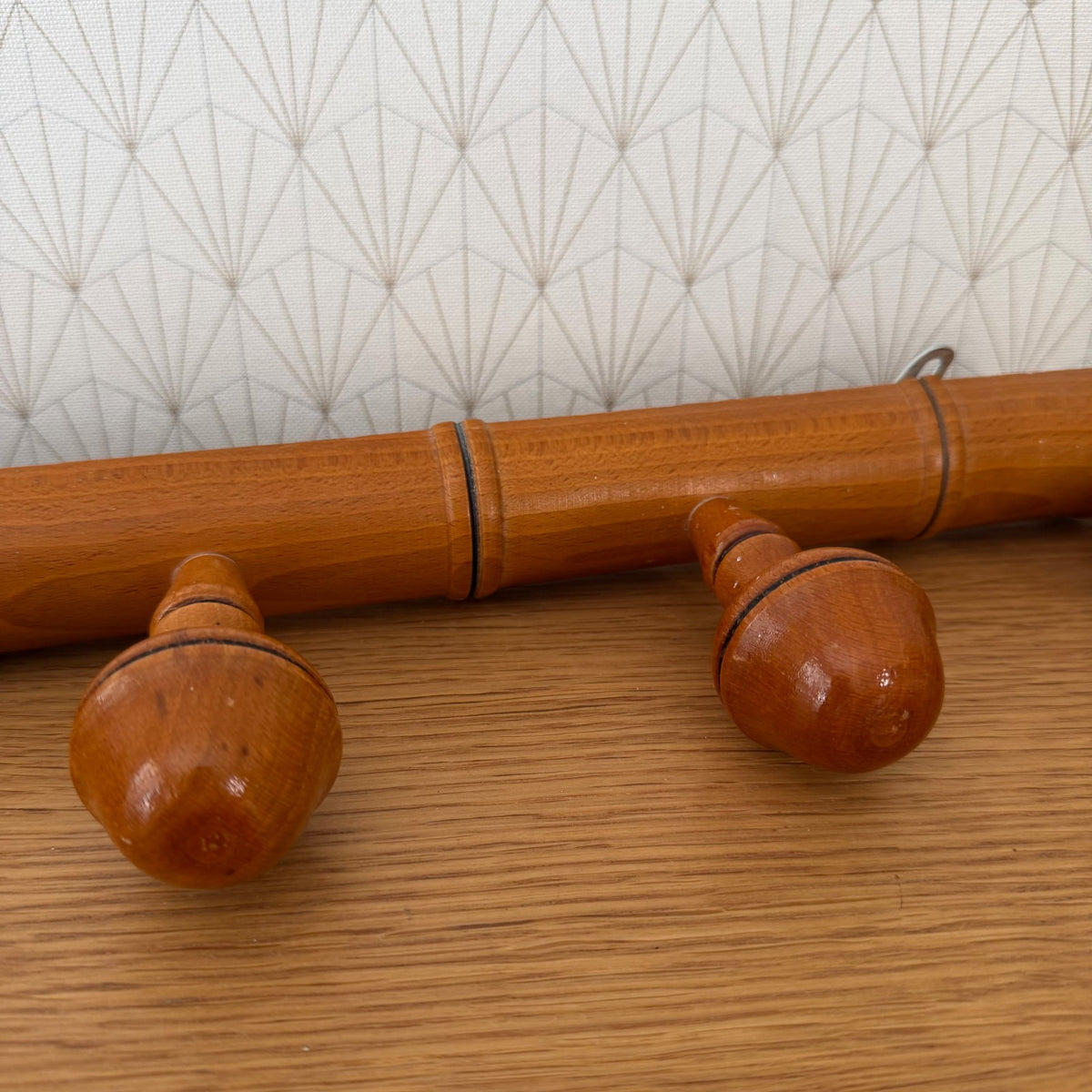 Full length view of vintage French bamboo coat rack with all five pegs visible