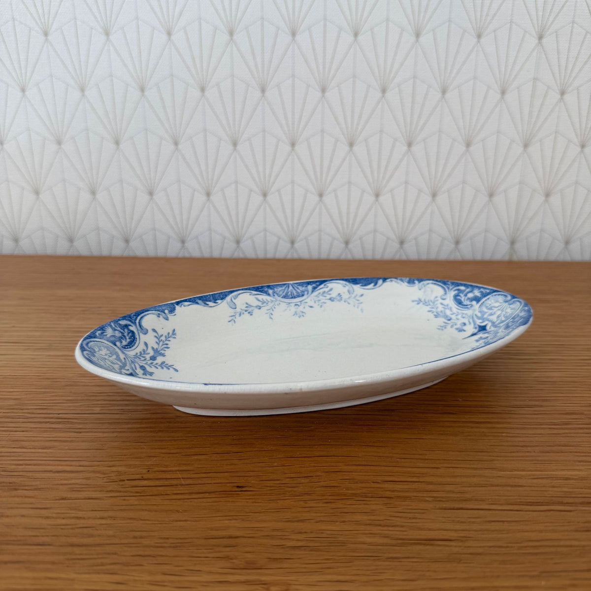 Antique Luneville faience oval serving dish with blue and white scrolled acanthus leaf border design