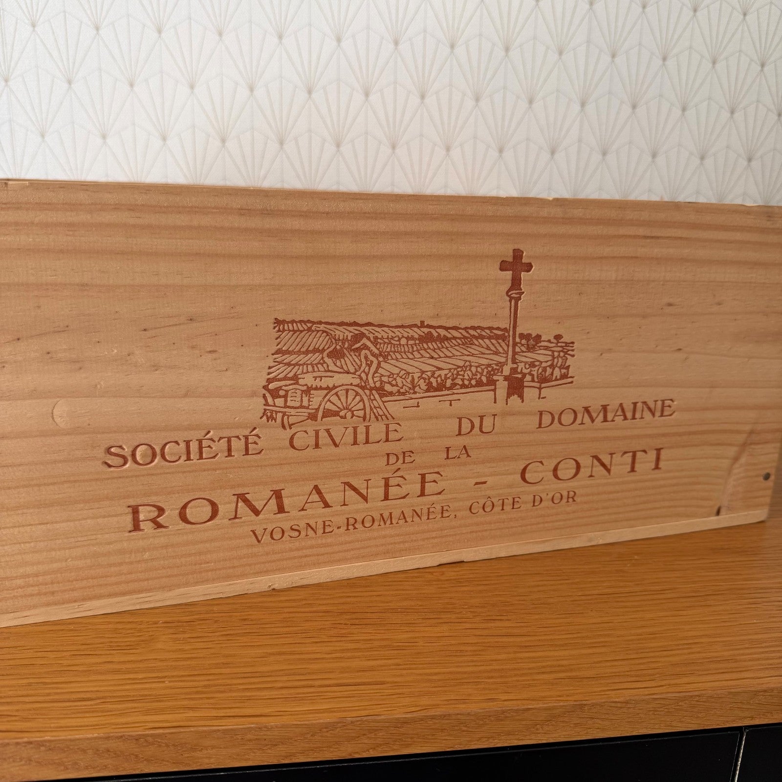 Close-up of laser-engraved text and vineyard scene on authentic French wooden wine crate