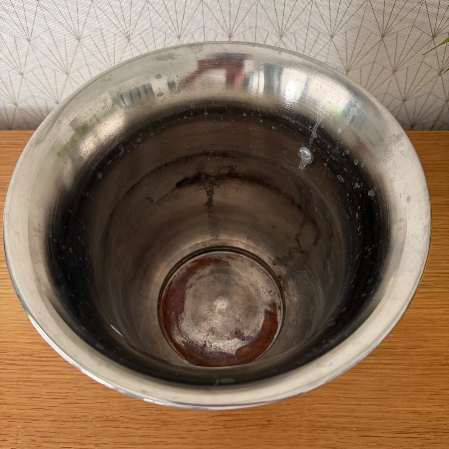 Interior of vintage Ruinart champagne ice bucket showing polished chrome finish