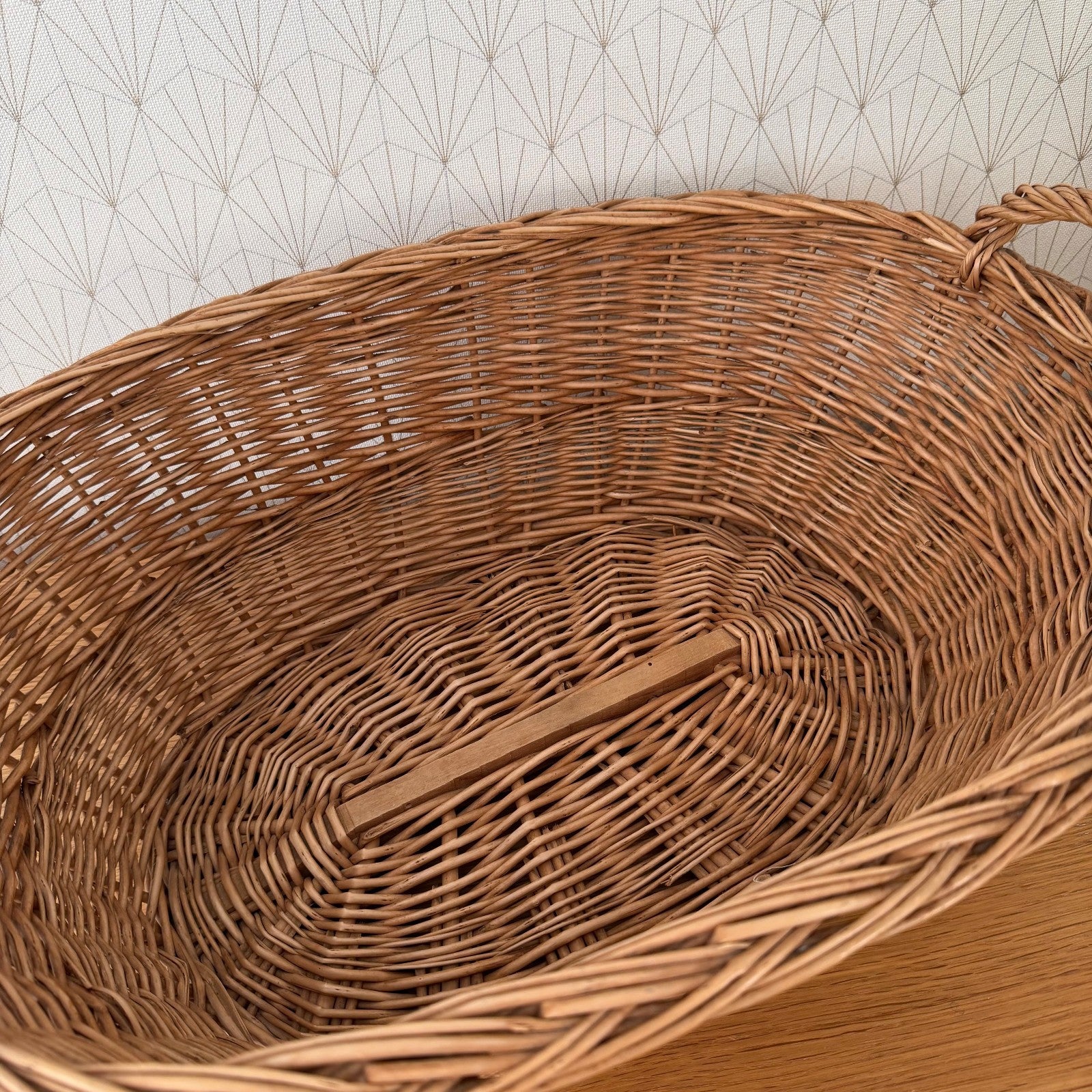 Close-up interior view of hand-woven rattan weave pattern in French laundry basket