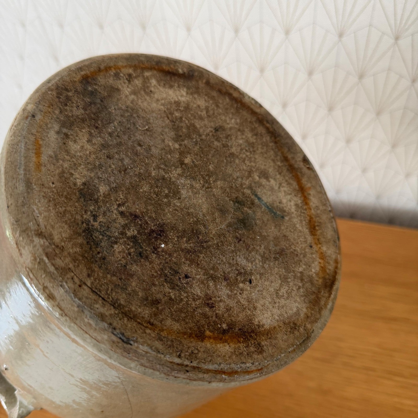 Bottom detail of French antique confit pot showing unglazed base and manufacturing marks