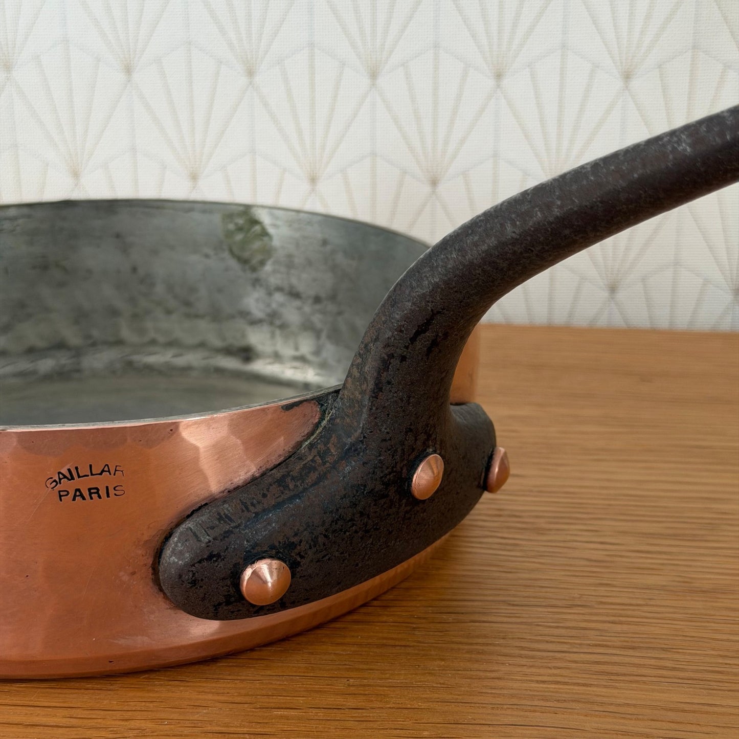Side profile of vintage Gaillard copper saute pan showing handle and tin interior