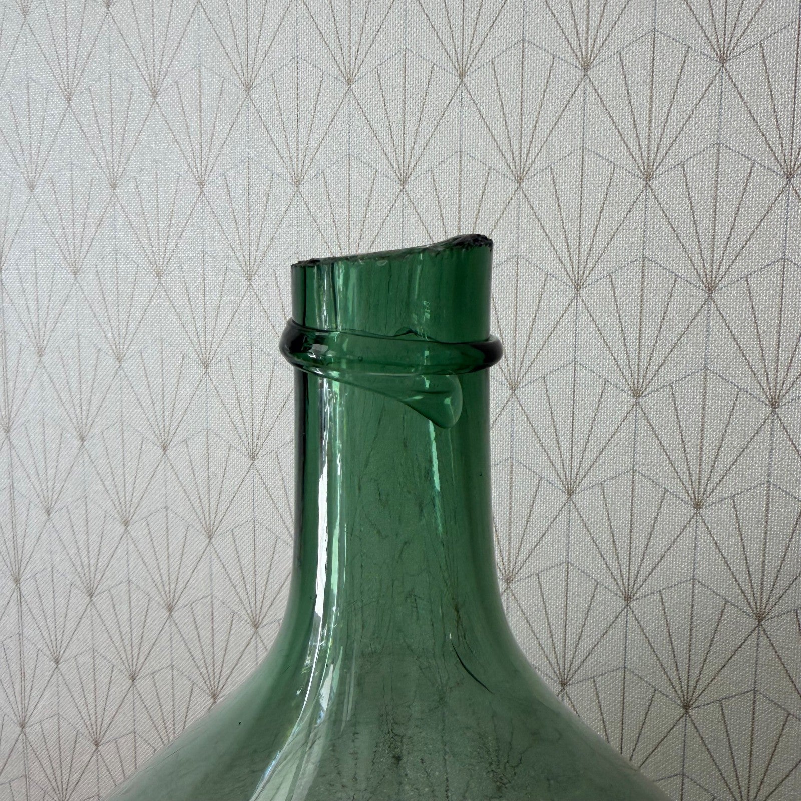 Close-up detail of cork closure and neck of vintage French glass demijohn bonbonne