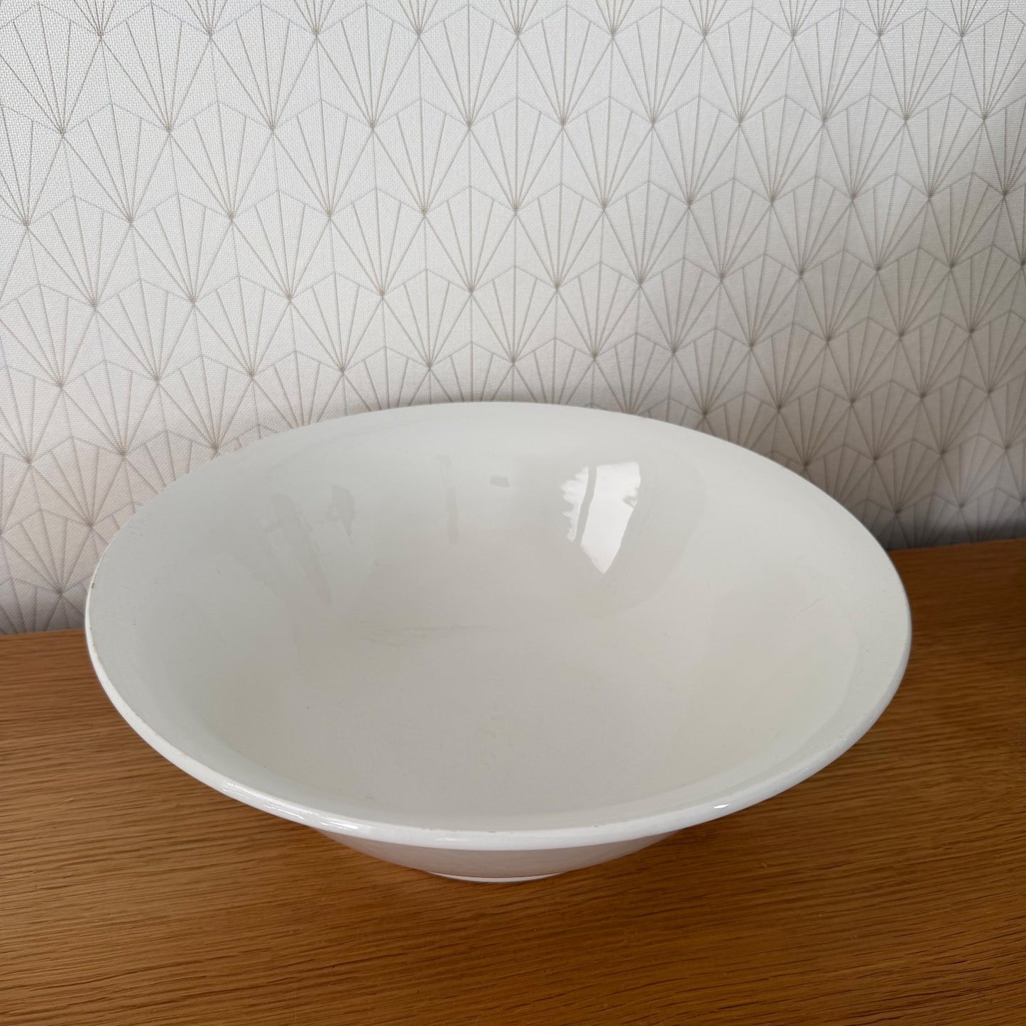 Top-down view of large white ceramic bowl with smooth interior glaze