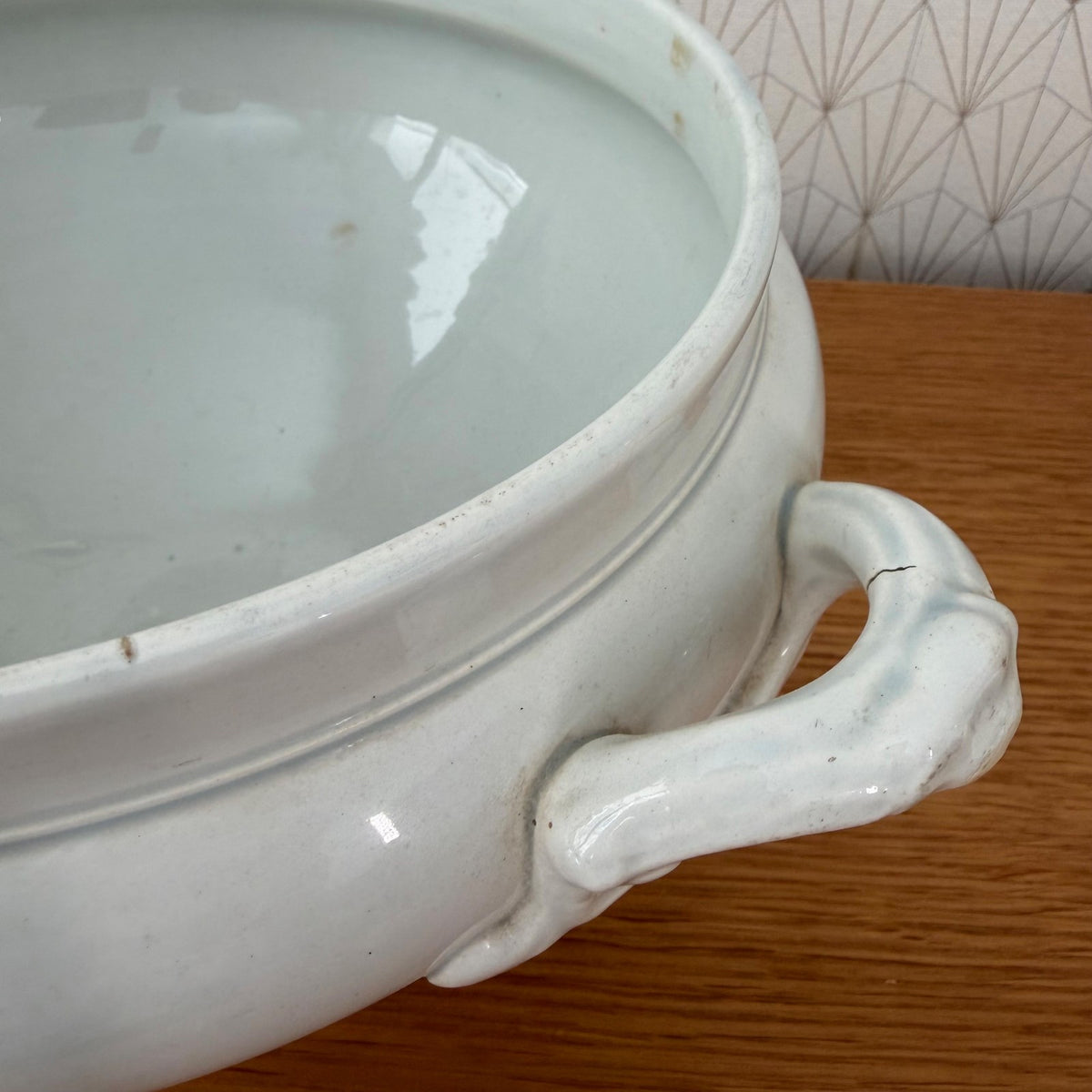 Close-up of molded handles and body detail on 19th century faience tureen