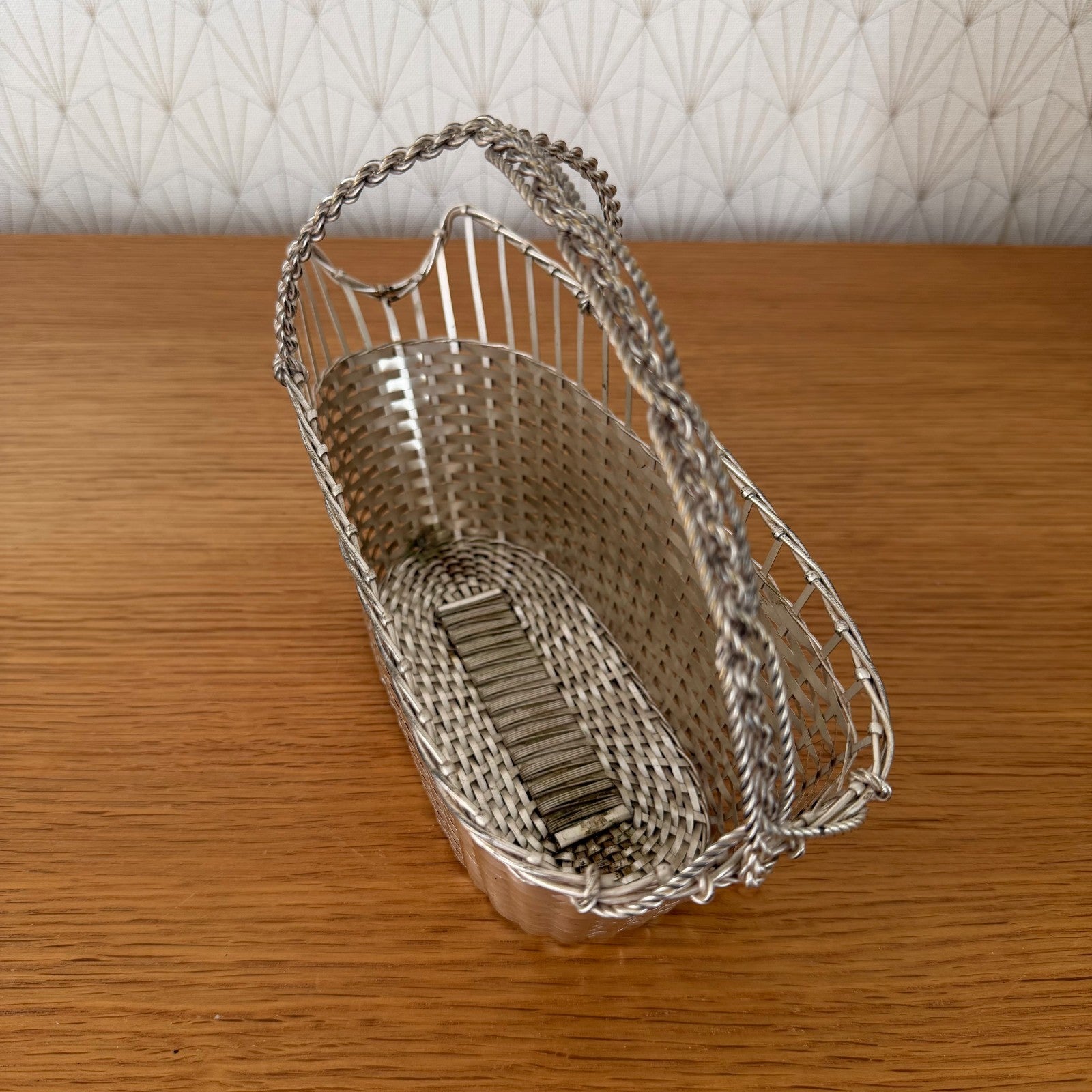 Vintage French wine basket base detail with woven metal strips and finish