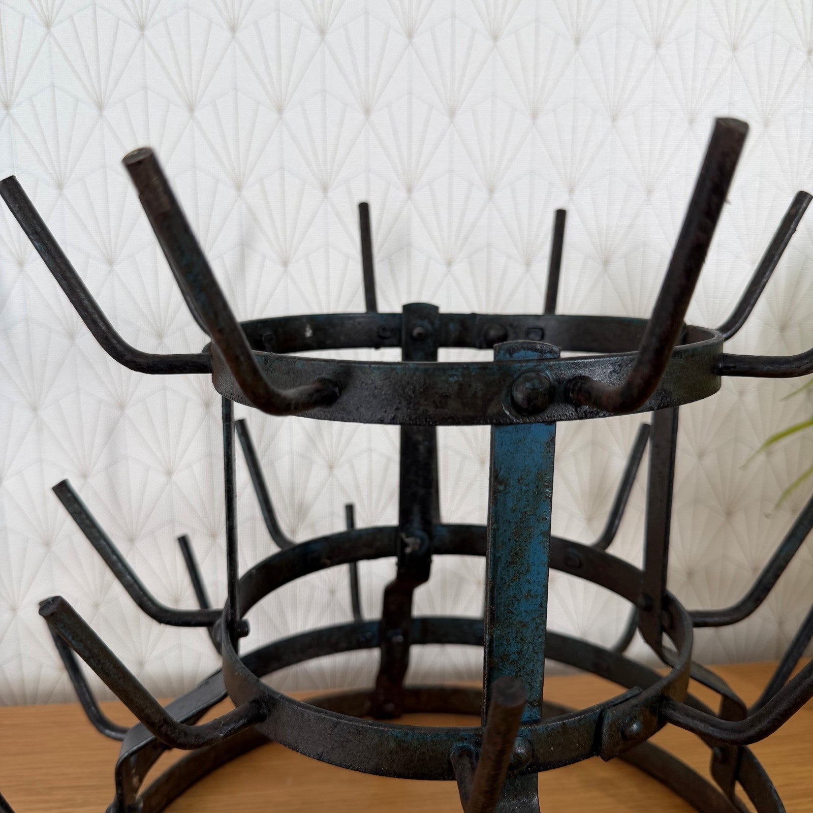 Close-up of middle tier showing hand-forged iron construction and riveted details of vintage French drying rack