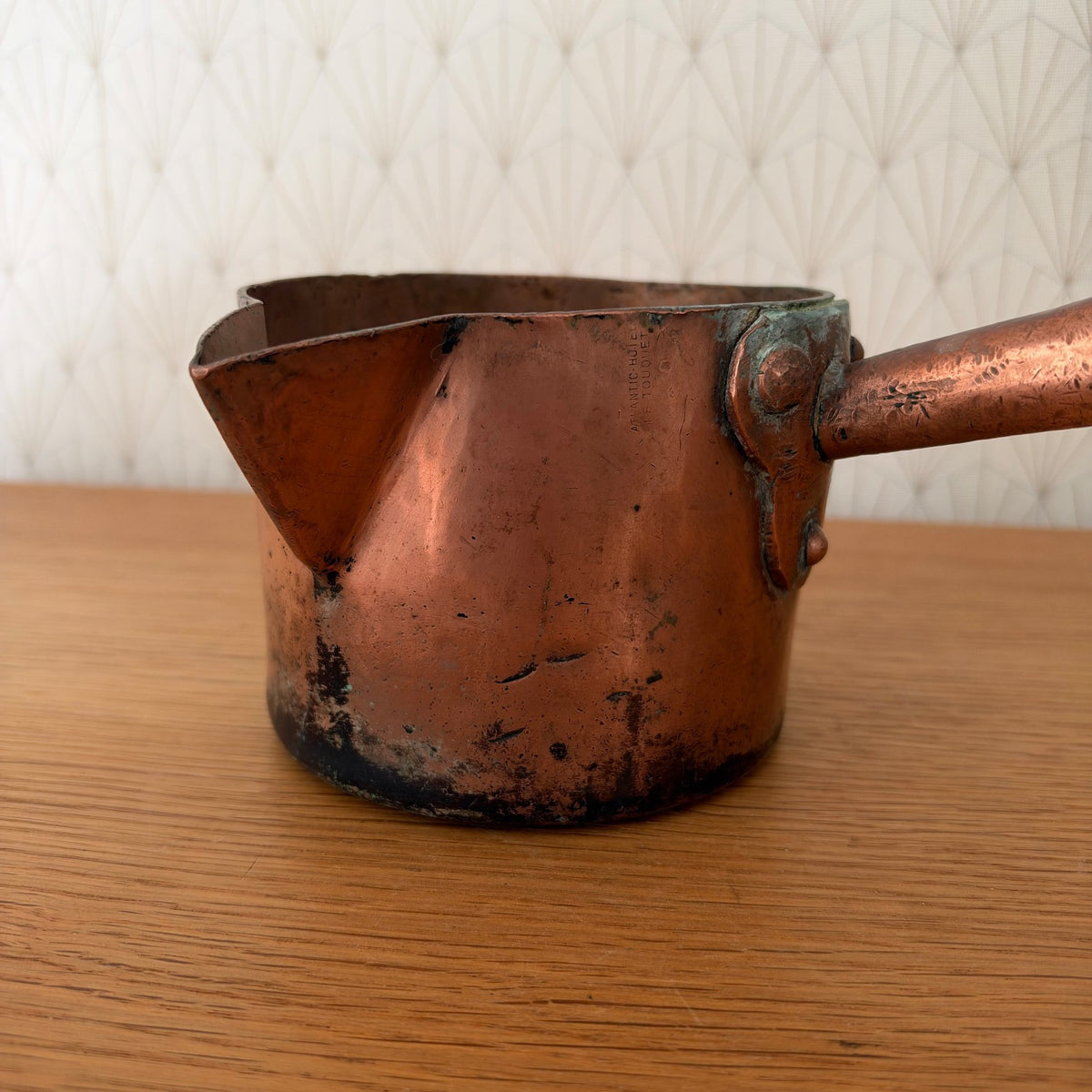 Close-up of E. Dehillerin Paris oval stamp on copper sugar pan body with patina