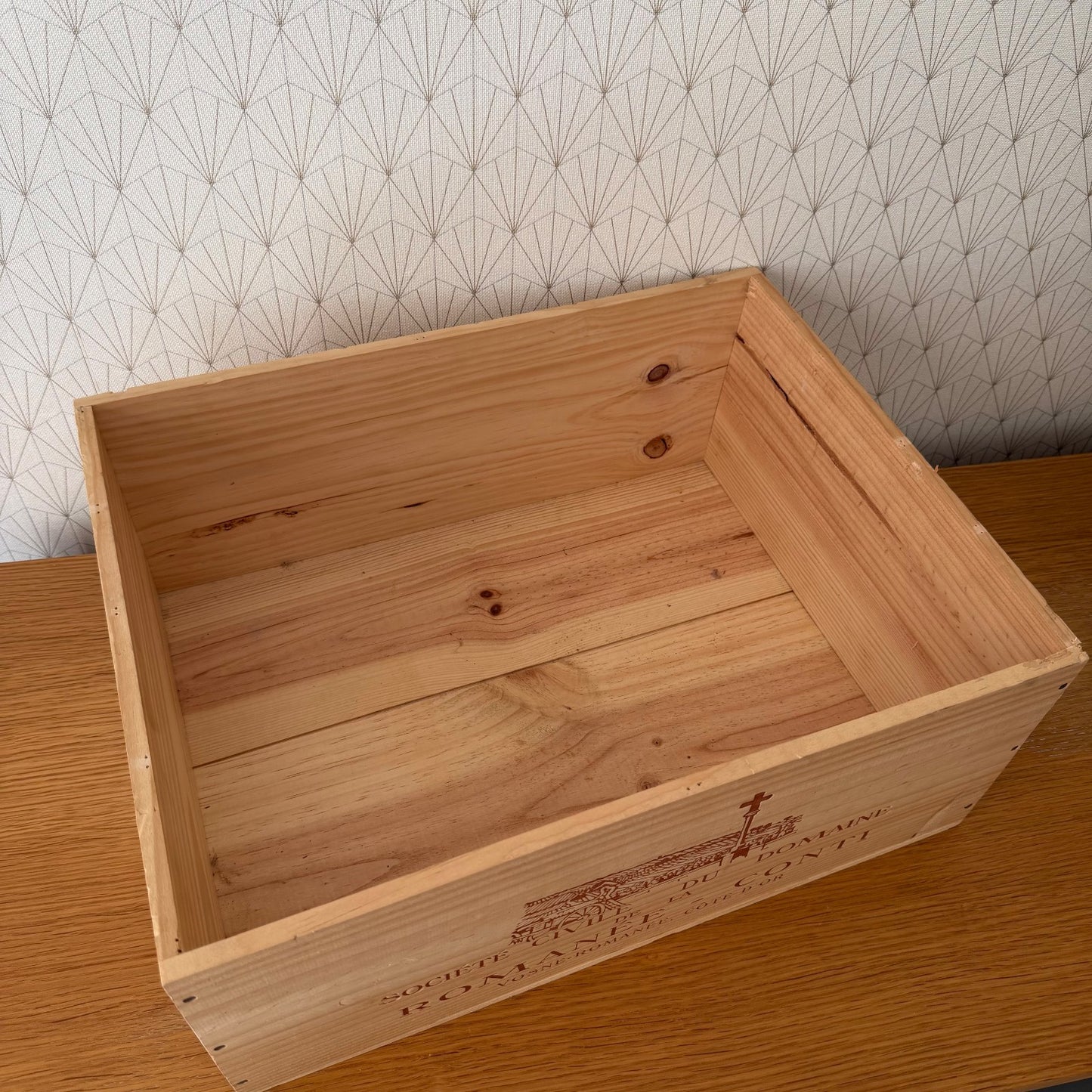 Empty interior of vintage French wine crate showing natural wood construction and dovetail joinery