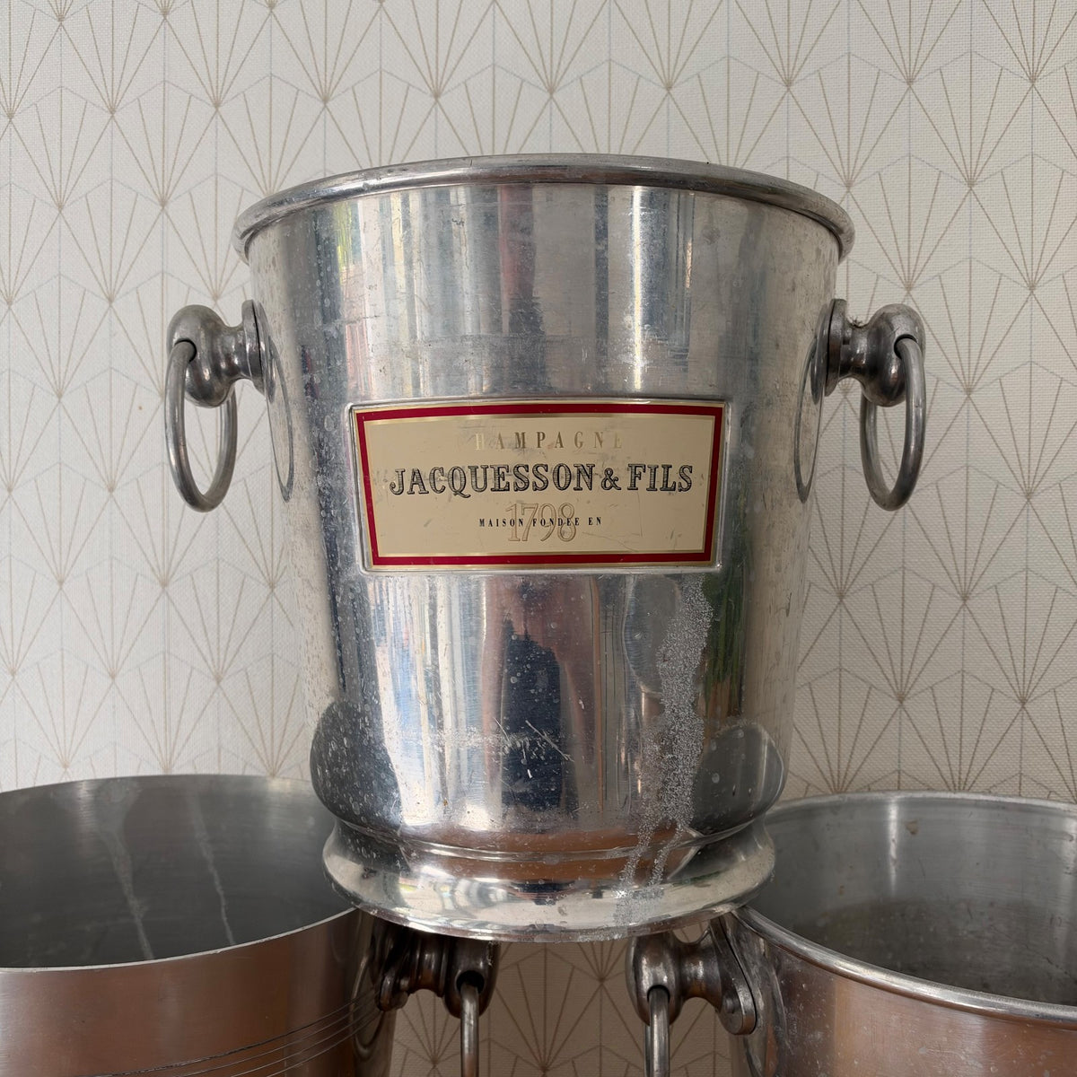 Jacquesson champagne ice bucket with decorative ring detail around base and twin handles