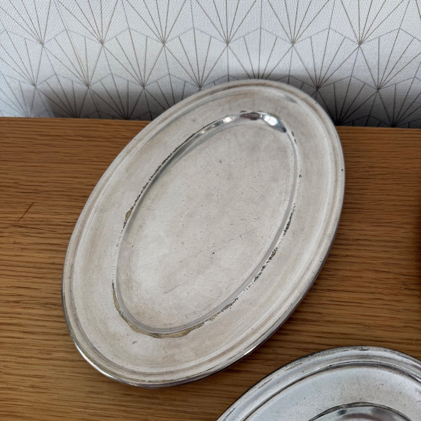 Detailed view of French silver plated oval ravier tray with raised ridge and professional finish