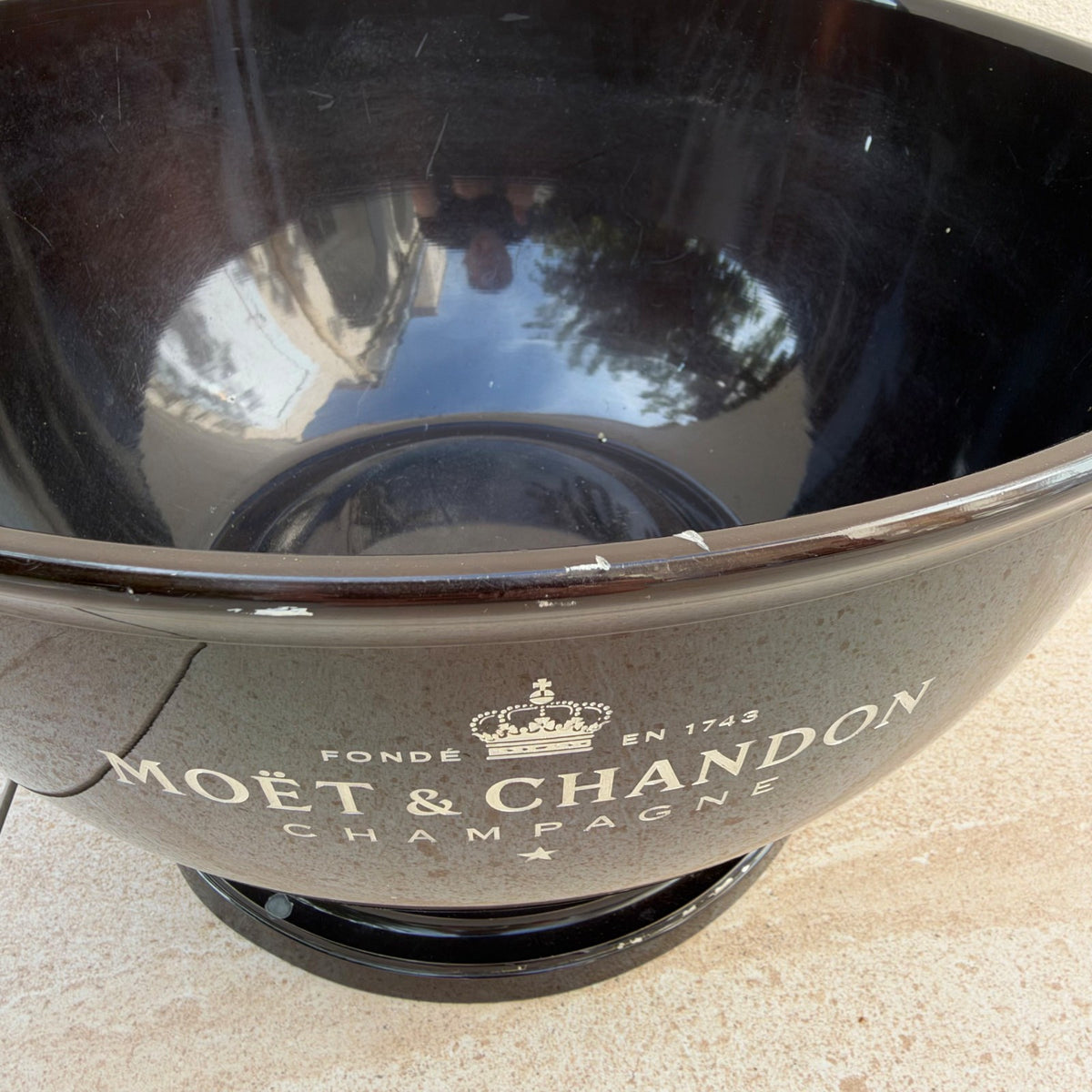 Interior view of polished black Moet Chandon ice bucket showing deep bowl design