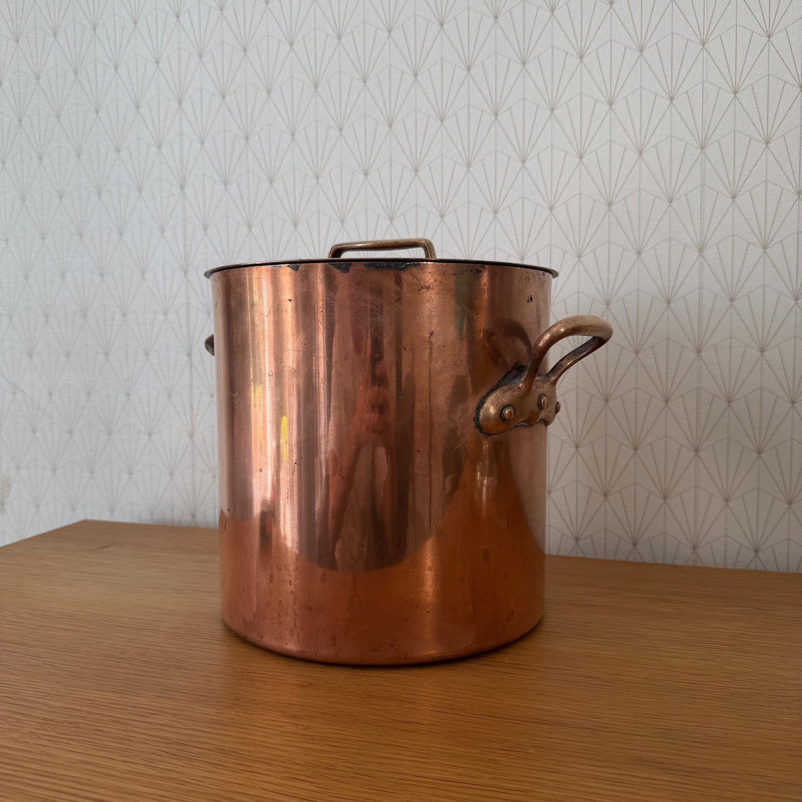 Antique French copper stock pot showing brass side handle detail and construction