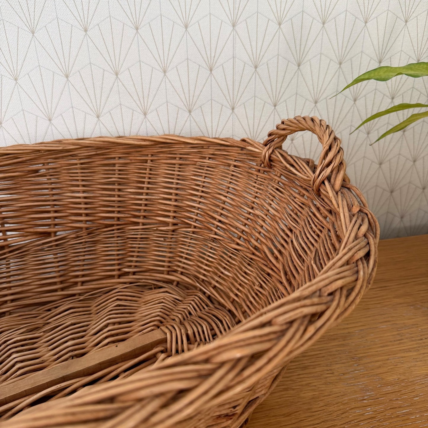 Detail of braided rope handles on vintage French wicker storage basket