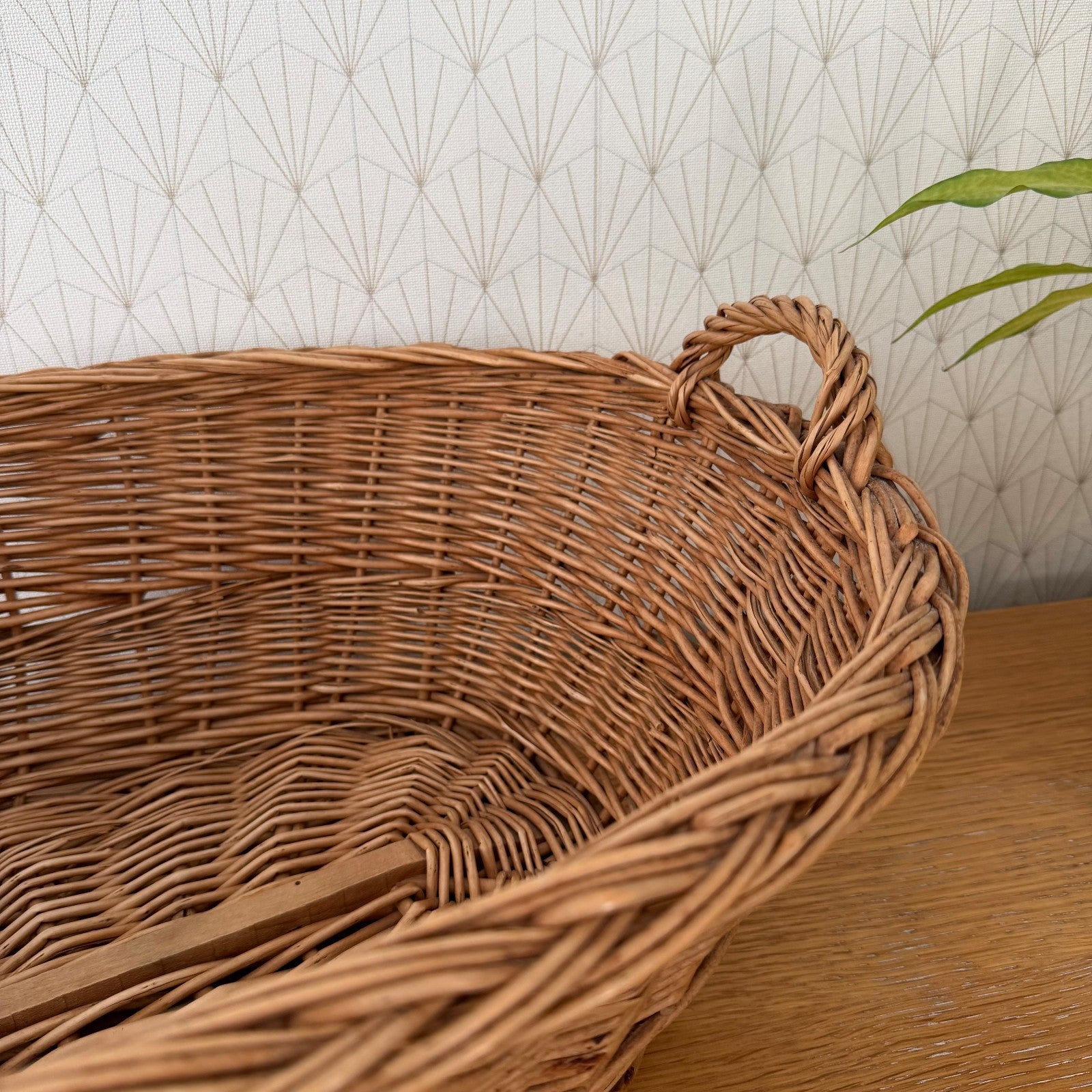 Detail of braided rope handles on vintage French wicker storage basket