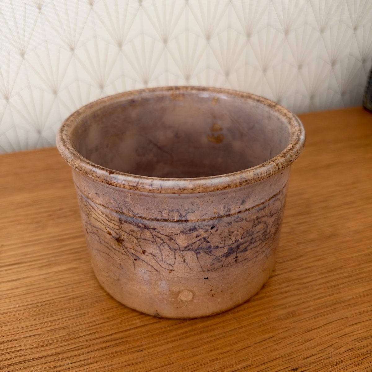 Three-quarter view of antique French Sarreguemines stoneware crock, showing blue-grey decorative band and aged patina.