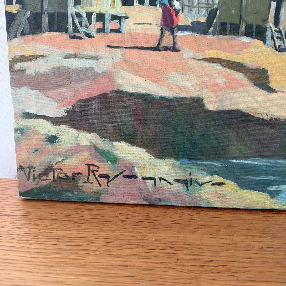 Close-up of the artist signature on the vintage oil painting on canvas, reading Victor Ry- followed by additional script letters