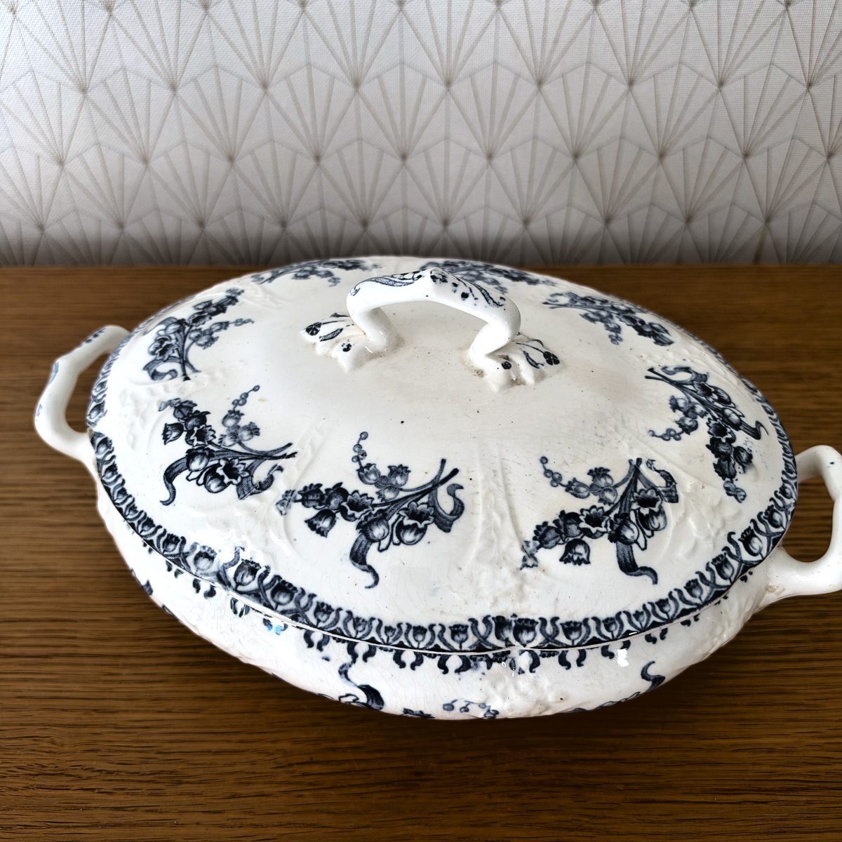 Overhead angle of French transferware tureen showing full lid decoration with bell-flower garlands and border pattern.