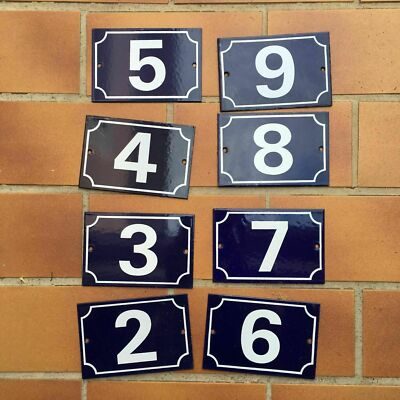 Vintage French municipal enamel house number sign with bold white numeral on deep blue steel background, 10x15cm, showing authentic weathering and edge wear from street use.