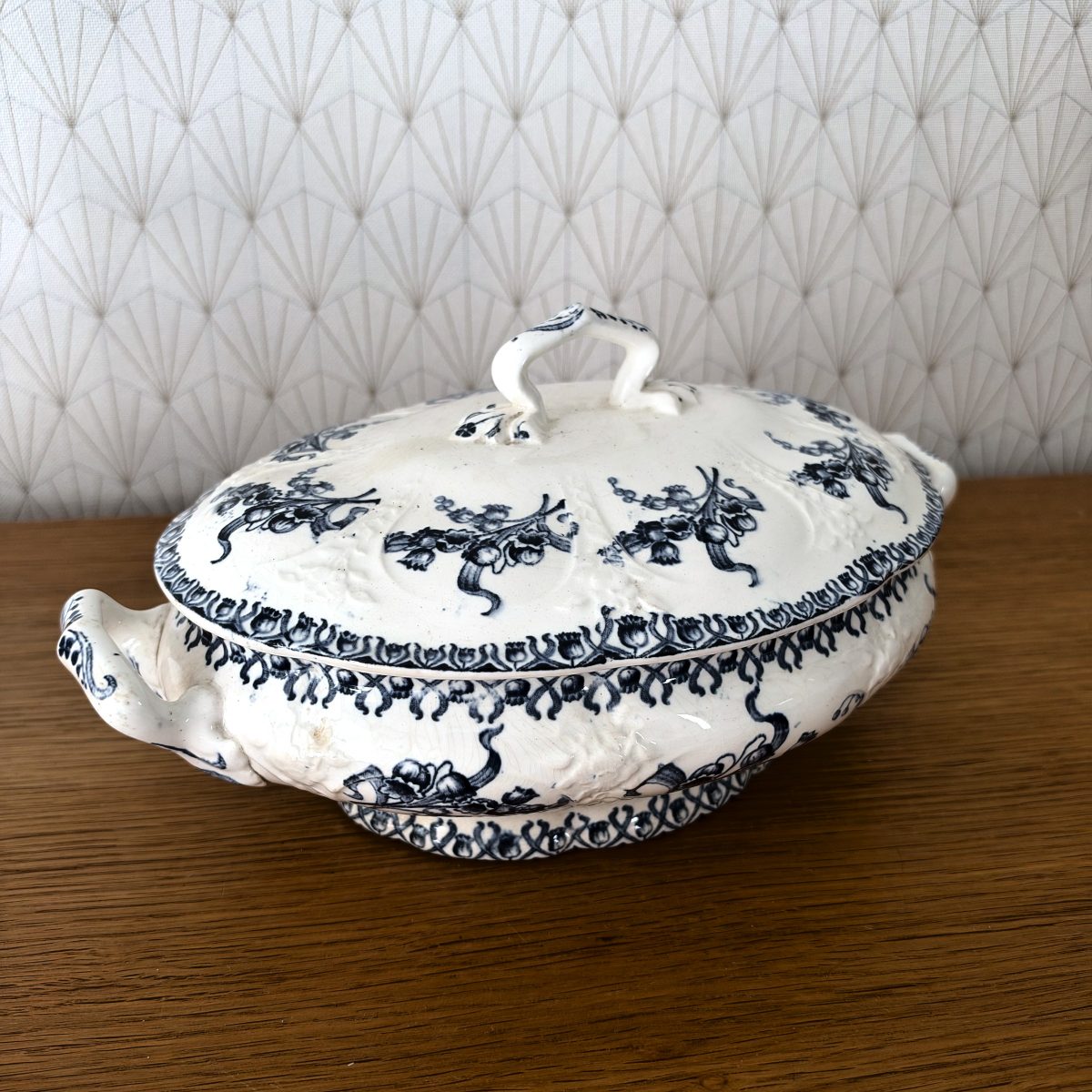 Antique French blue white transferware tureen, three-quarter view showing floral transfer print and scrolled handles.