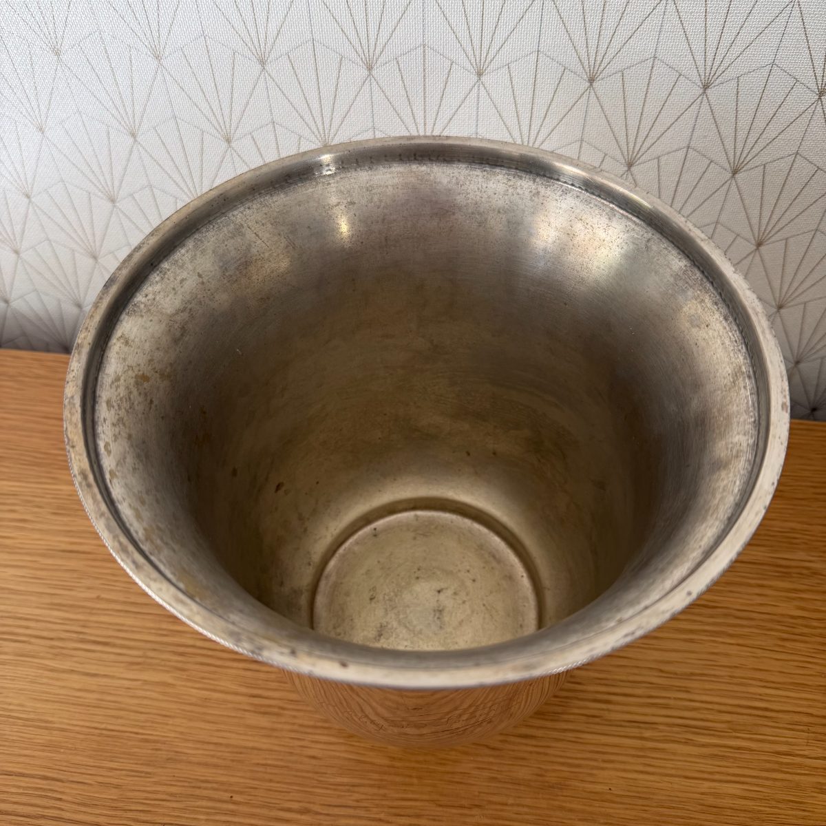 Interior top-down view of French silver plated champagne bucket showing aged patina and raised center base.