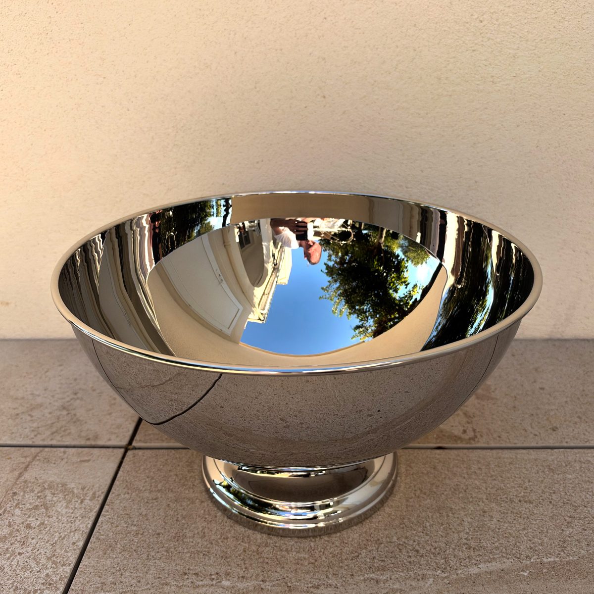 Guy Degrenne Aphrodite punch bowl without the flute rack, showing the clean mirror-polished interior and rolled rim.