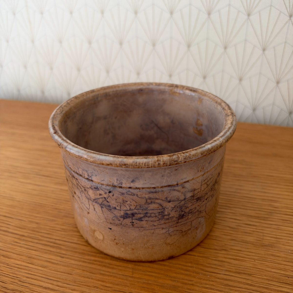 Top-angled view of antique French Sarreguemines stoneware crock showing open interior and rolled rim, warm beige glaze.