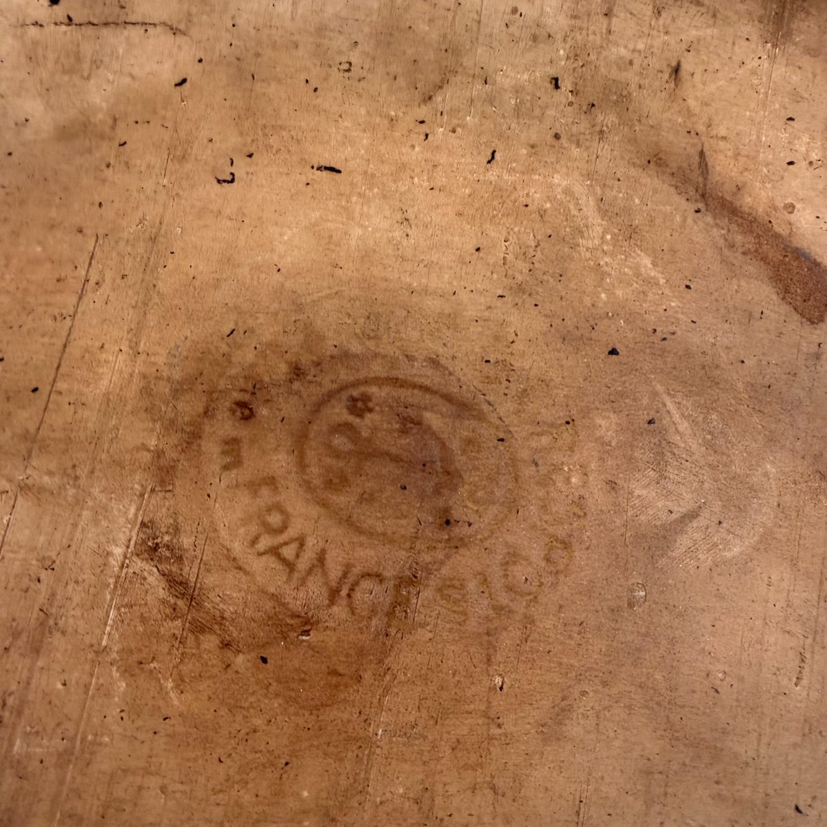 Faint maker's mark stamped on unglazed base of French terracotta baking dish reading FRANCE within a circular cartouche.