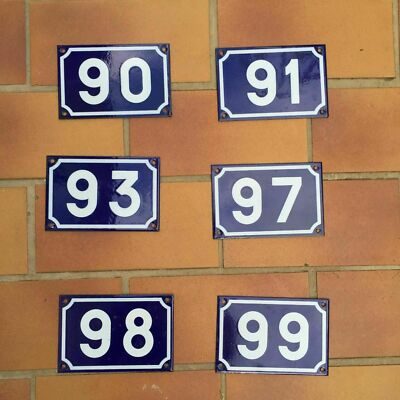 Vintage French enamel house number sign showing white numeral on deep navy blue background, porcelain on steel, 10x15cm, with authentic surface wear from street use